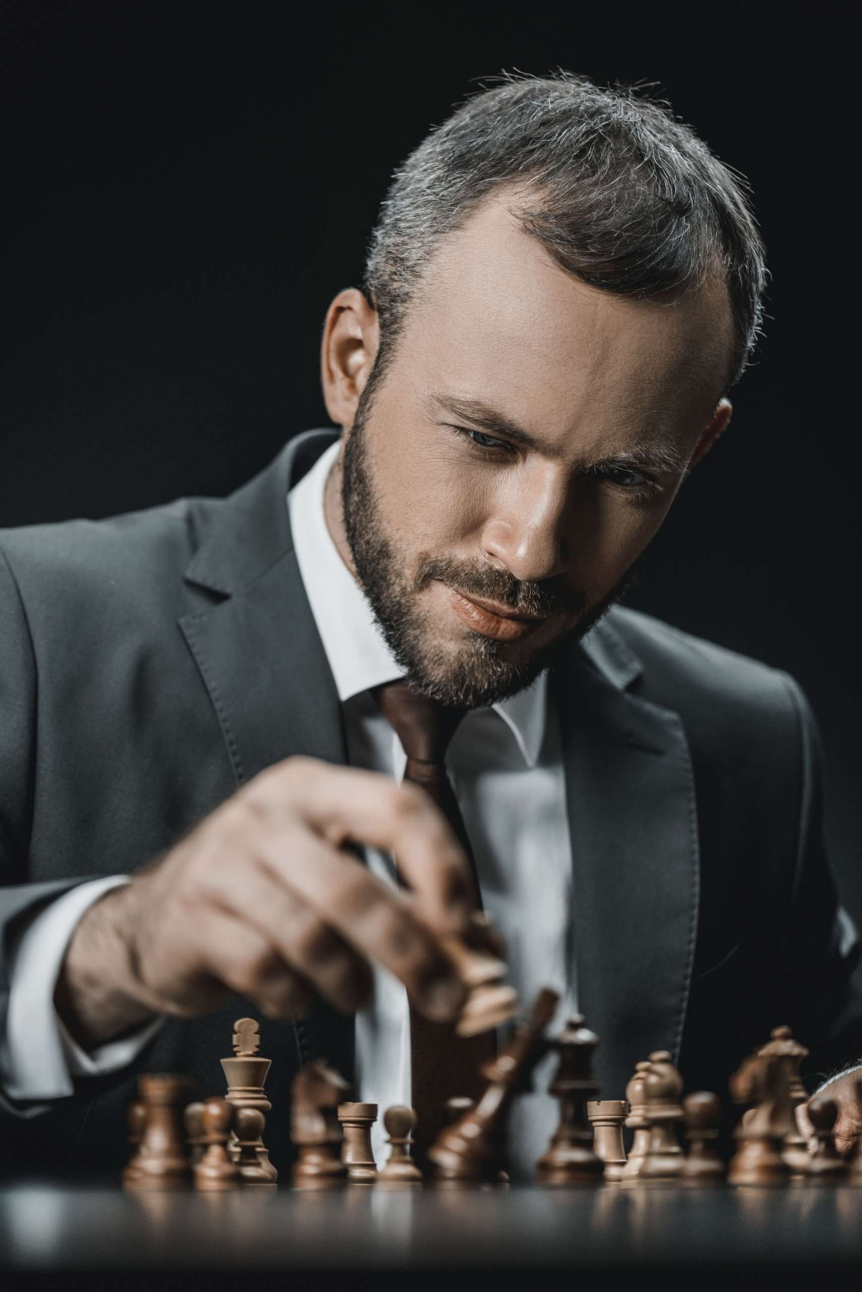 portrait-of-focused-businessman-playing-chess