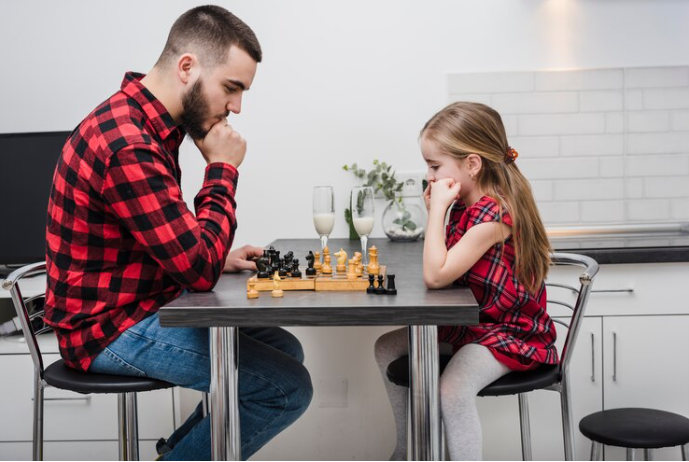 expert coach teaching chess to beginner