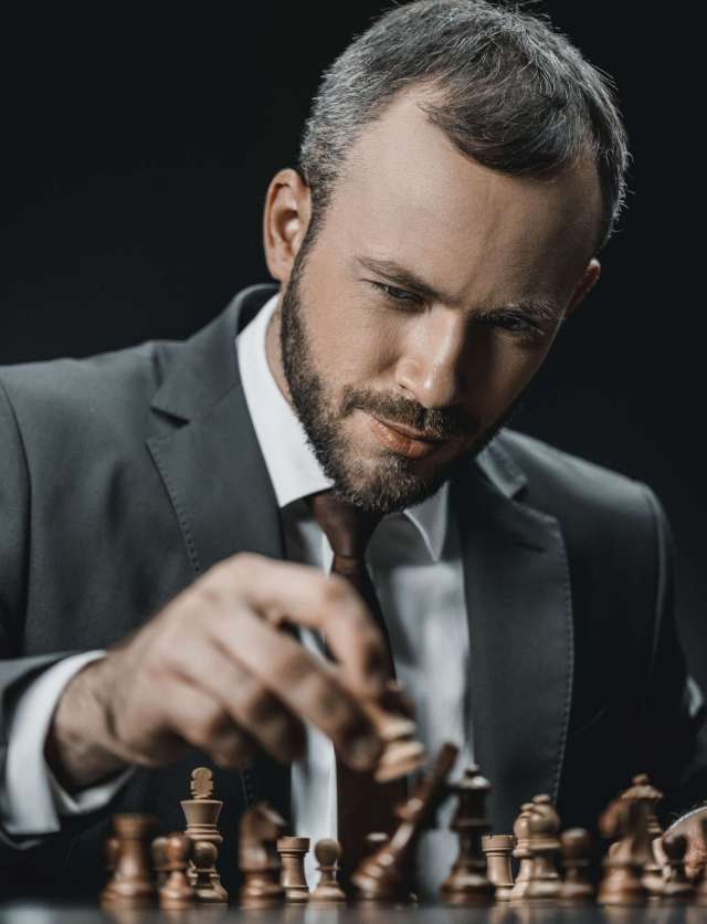 portrait-of-focused-businessman-playing-chess