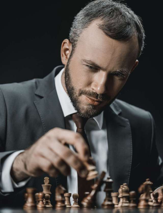 portrait-of-focused-businessman-playing-chess